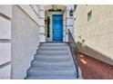 Close up of the home's front entrance with steps leading up to a bright blue front door at 7665 Sandhaven St, Las Vegas, NV 89139