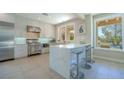 Modern kitchen with stainless steel appliances, waterfall island, and sleek white cabinetry at 7999 Pinnacle Peak Ave, Las Vegas, NV 89113