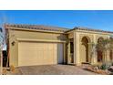 Beautiful front exterior showcasing a well-maintained lawn, arched entryway, and two-car garage at 8144 Skye Dragon St, Las Vegas, NV 89166