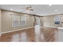 Neutral-toned living room with wood-style flooring and natural light at 8683 Bella Jewel Ave, Las Vegas, NV 89178