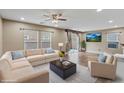 Bright living room with modern furniture and wood-style flooring at 8683 Bella Jewel Ave, Las Vegas, NV 89178