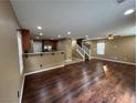 Spacious living room featuring hardwood floors seamlessly flowing into the kitchen area at 8683 Bella Jewel Ave, Las Vegas, NV 89178