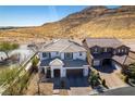 Inviting two-story home with a neutral color scheme, desert landscaping, and mountain views at 9519 Chandler Springs Ave, Las Vegas, NV 89148