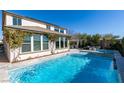 Relaxing backyard pool and spa with an outdoor kitchen and seating area at 9519 Chandler Springs Ave, Las Vegas, NV 89148