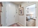 Inviting entryway with a white front door leading into a cozy, carpeted bedroom at 9655 Shadow Cliff Ave, Las Vegas, NV 89166