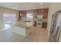 Bright eat-in kitchen features an island, dark cabinets, and stainless steel appliances at 9870 Giant Steps Ct, Las Vegas, NV 89141