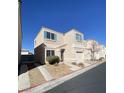 A two-story single Gathering home with a one-car garage, landscaped front yard and driveway at 10047 Fine Fern St, Las Vegas, NV 89183