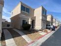 A two-story single Gathering home with a one-car garage, landscaped front yard and driveway at 10047 Fine Fern St, Las Vegas, NV 89183