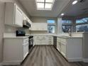 Bright and airy kitchen with modern appliances, stylish cabinets, and a skylight at 10301 Broom Hill Dr, Las Vegas, NV 89134