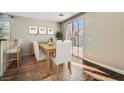 Cozy dining area features hardwood floors, access to the outdoor patio, and stylish decor at 336 S Milan St, Henderson, NV 89015
