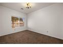 Cozy bedroom with neutral carpeting, a ceiling light fixture, and a window providing natural light at 341 Grapevine Rd, Mesquite, NV 89027