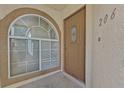 Entryway with an arched window and front door to unit 206 at 3672 Angela Robin St # 206, Las Vegas, NV 89129