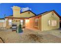 Single-story house, manicured front yard, brick driveway, warm exterior lighting, and cozy desert charm at 4055 Planetary Ln, Las Vegas, NV 89115