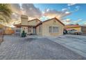 A single-story home showcasing its unique brick driveway, low maintenance yard, and serene desert landscape at 4055 Planetary Ln, Las Vegas, NV 89115