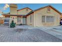 Single-story home showing desert landscaping, unique brick driveway, and well-maintained front exterior at 4055 Planetary Ln, Las Vegas, NV 89115