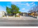 Charming single-story home featuring a well-manicured lawn, complemented by a lush tree at 4258 E Twain Ave, Las Vegas, NV 89121