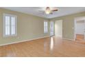 Bright living area with wood floors, ceiling fan, and natural light streaming from white shuttered windows at 602 Paloma Dr, Boulder City, NV 89005
