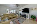 Bright living room featuring a comfortable sectional sofa, fireplace, and large TV at 6149 Vista Verde, Las Vegas, NV 89146