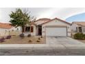 Charming single-story home with a red tile roof, neutral stucco, and a two-car garage at 629 Bright Lights Ave, North Las Vegas, NV 89031