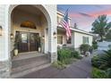 Close up of the front entrance with double doors and an American flag on the porch at 7600 Pleasant Colony Ct, Las Vegas, NV 89131