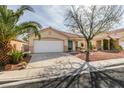 Charming single-story home featuring a two-car garage and desert landscaping at 9378 Spellman Ct, Las Vegas, NV 89123