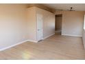 Bright living room with neutral paint, light wood-look floors and recessed lighting at 9424 Fox Forest Ave, Las Vegas, NV 89129