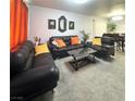 Open-concept living room featuring modern furniture, minimalist decor, and access to the dining area at , Las Vegas, NV 89183