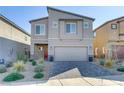 Charming two-story home boasts desert landscaping, a paver driveway, and a welcoming red front door at 10785 Wild Parsley Ave, Las Vegas, NV 89129