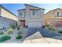 Charming two-story home boasts desert landscaping, a paver driveway, and a welcoming red front door at 10785 Wild Parsley Ave, Las Vegas, NV 89129