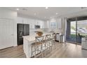 Bright kitchen with white cabinets, stainless steel appliances, and an island with bar seating at 12541 Lylan Ridge St, Las Vegas, NV 89138