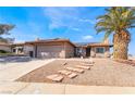 Inviting single-story home with a tidy front yard, desert landscaping, and a two-car garage at 181 Lido Cir, Henderson, NV 89015