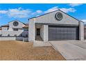 One-story home with a two-car garage, well-kept lawn, and a white exterior at 1905 Joella St, Las Vegas, NV 89108