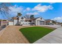 Spacious single-story home showcasing a well-manicured lawn and a two-car gray garage door at 1905 Joella St, Las Vegas, NV 89108