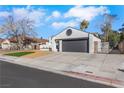 Single-story home with an attached two-car garage, well kept lawn, and white stucco exterior at 1905 Joella St, Las Vegas, NV 89108