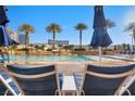 Relaxing poolside loungers with palm trees and resort buildings in the background at 2000 N Fashion Show Dr # 5326, Las Vegas, NV 89109