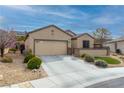 Charming single-story home with a well-maintained lawn and desert landscaping at 2392 Mystic Star St, Henderson, NV 89044