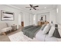 Bright, staged main bedroom with plush bedding, neutral decor, and an arched doorway to the main bathroom at 2478 Cordoba Bluff Ct, Las Vegas, NV 89135