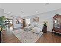 Bright living room with hardwood floors, a neutral palette, and a comfortable sofa at 2597 Belgreen St, Las Vegas, NV 89135