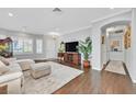 Spacious living room featuring hardwood floors, neutral paint, large windows, and an open floor plan at 2597 Belgreen St, Las Vegas, NV 89135