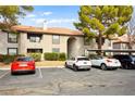 Exterior view of a building showcasing parking spaces and well-maintained landscaping at 2606 S Durango Dr # 276, Las Vegas, NV 89117