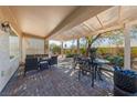 Spacious covered patio with brick flooring and outdoor dining furniture; perfect for entertaining at 2921 Hayden Creek Ter, Henderson, NV 89052