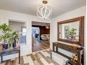 Inviting entryway with modern light fixture, stylish flooring, and a glimpse into the spacious living area at 321 Agora Way, Las Vegas, NV 89110