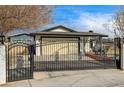 Charming single-story home behind an ornate black iron gate offering curb appeal and security at 321 Agora Way, Las Vegas, NV 89110