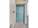 Inviting turquoise front door with modern hardware and a secure entry system at 382 Gracious Way, Henderson, NV 89011