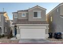 Charming two-story home featuring a two-car garage, tile roof, and low maintenance desert landscaping at 4833 Integrity St, North Las Vegas, NV 89031