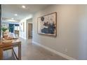 Inviting home entryway with neutral tile floors, modern artwork, and views to the dining area at 510 Copper Falcon Ave, Henderson, NV 89011