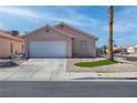 Single-story home with desert landscaping, two-car garage and paved driveway at 5541 Ramirez St, North Las Vegas, NV 89031