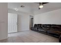 Inviting living room featuring neutral tile flooring and a comfortable leather sofa at 5541 Ramirez St, North Las Vegas, NV 89031