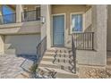 Inviting front entrance with a stylish door, well-lit steps, and manicured landscaping at 5606 Spring Trellis St, Las Vegas, NV 89113