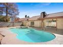 An in-ground pool with an attached spa is surrounded by concrete and desert landscaping in backyard at 6130 Desert Sun Dr, Las Vegas, NV 89110